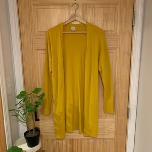 a new day long, mustard colored cardigan